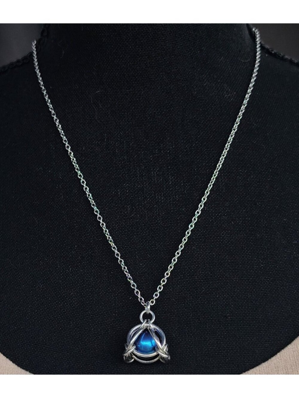 "Carriage Pod" pendant with an anodized titanium ball bearing